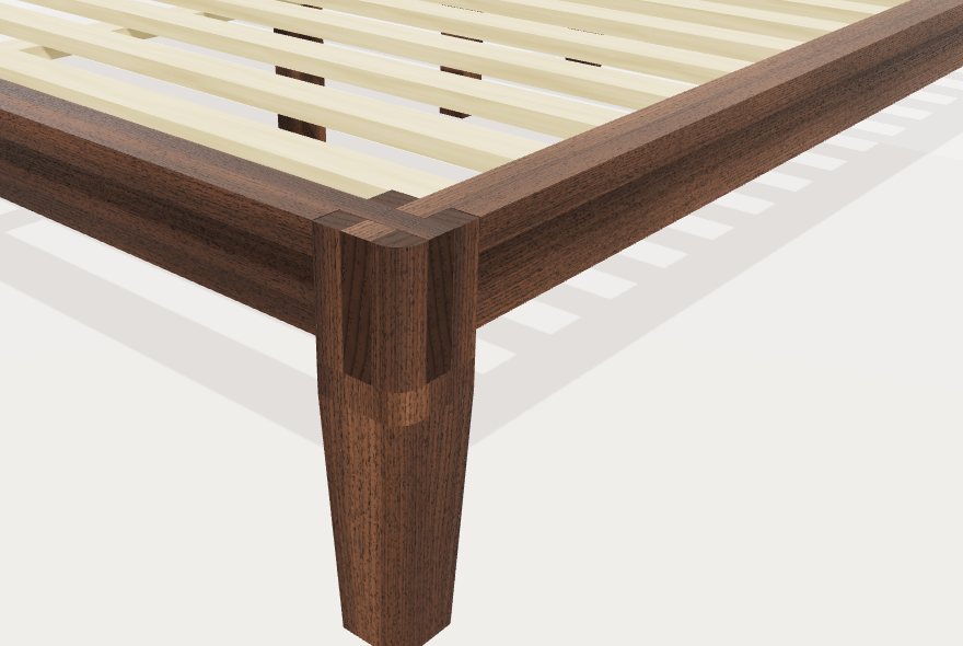 Close-up 3D view of a bed corner: a tapered walnut leg with the two rails crossing in slots cut into its top.